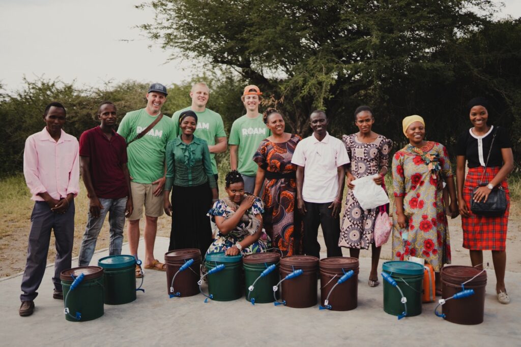 Grateful villagers showing buckets and filters